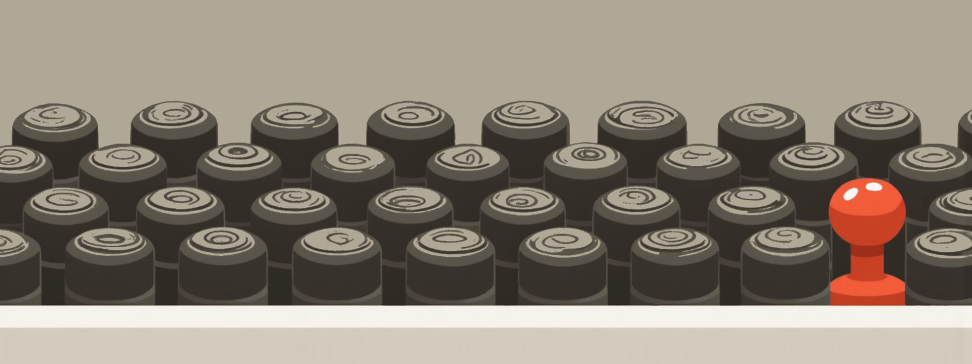 Rows of rubber stamps in a rack, one stamp handle in red.